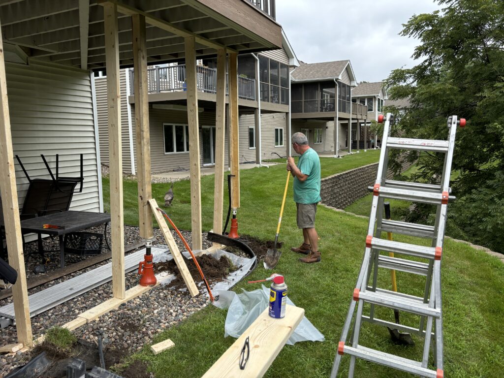 A professional fixing a damaged window during routine exterior repairs.